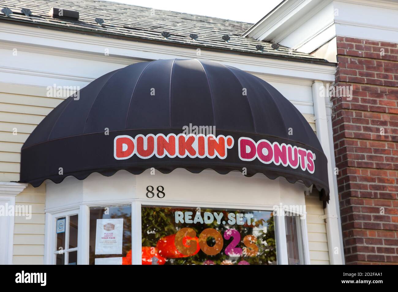 NEW CANAAN, CT, USA - OCTOBER 4, 2020: Dunkin` Donuts` store sign in New Canaan downtown  on Elm Street Stock Photo
